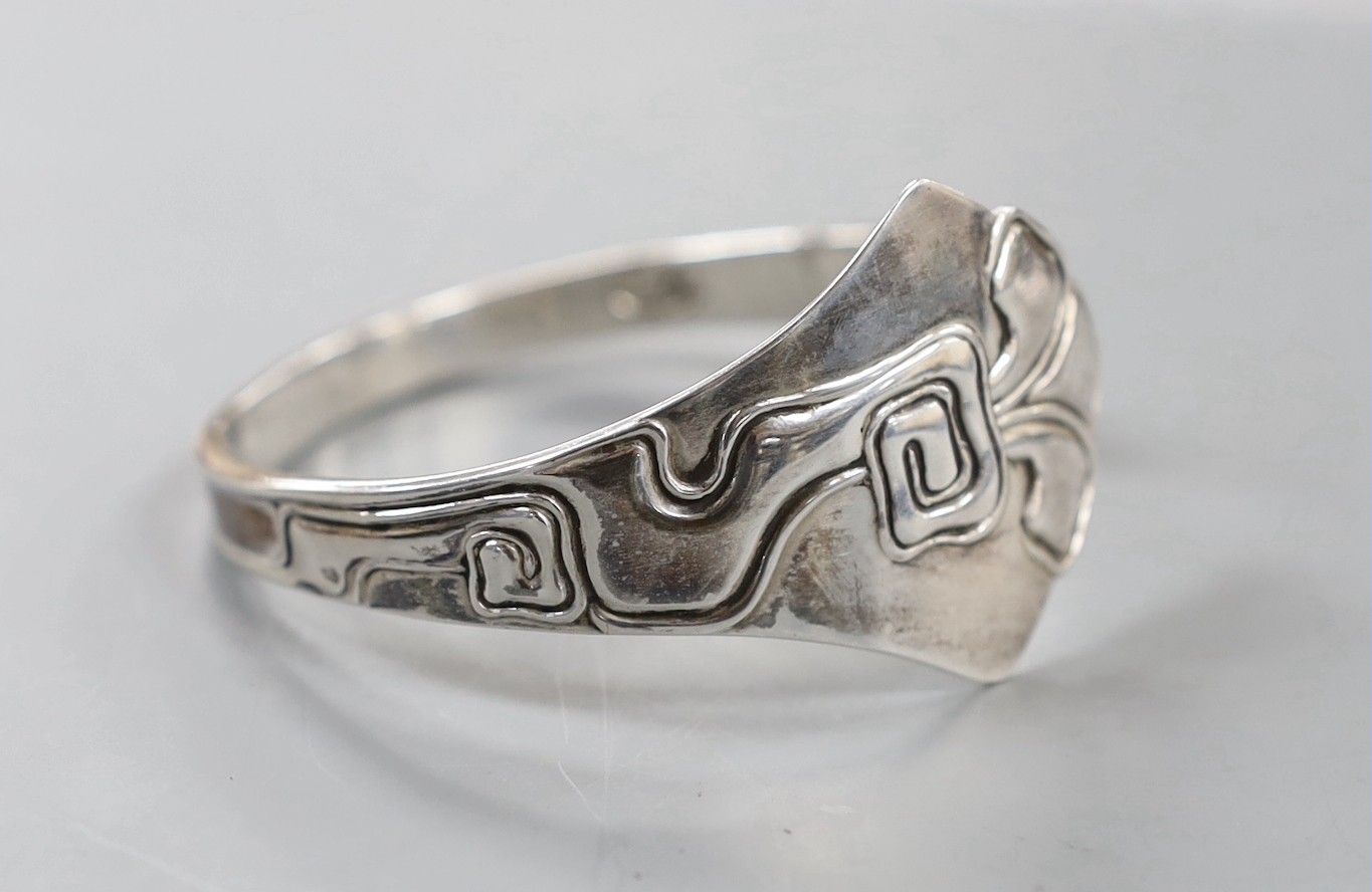 An early 20th century Danish sterling openwork bangle, dated for 1911, with later engraved inscription, assay master Christian F. Heise.